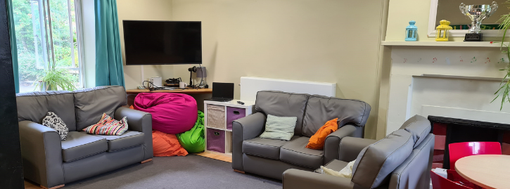 Living room with TV three sofas and dining table