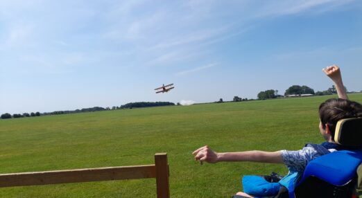 Student Justin cheering on a supporter taking part in the wing walk