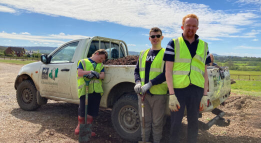 Sonny, Christopher and George smiling next to truck